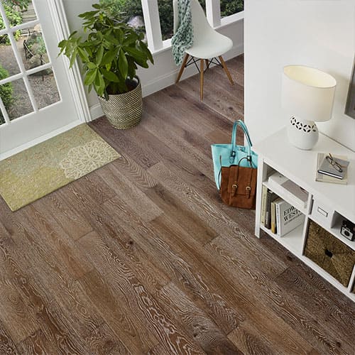 Rustic character grade hardwood floor with knots and wide color variation in a living room