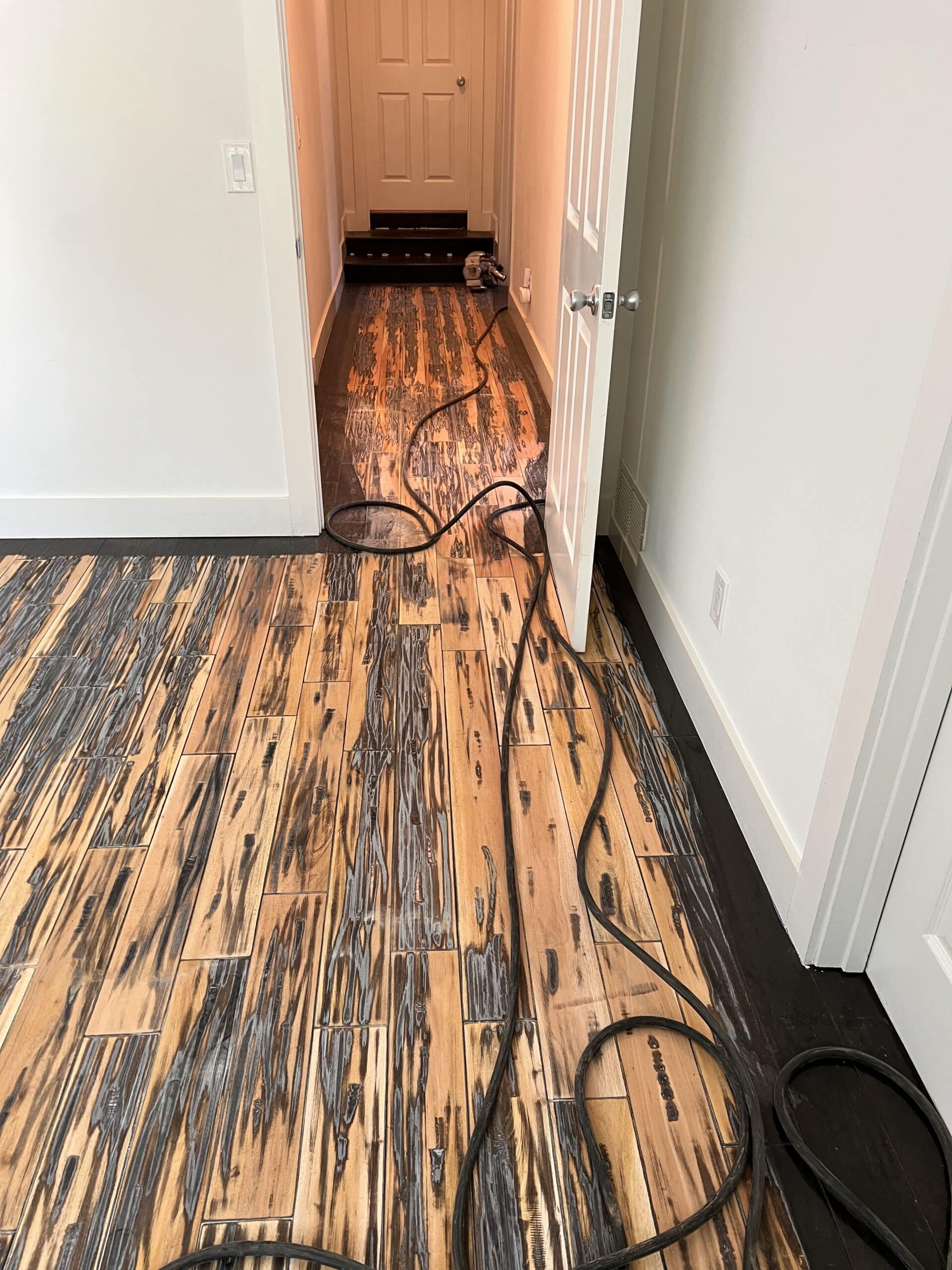 Worn dark hardwood floor before sanding and refinishing