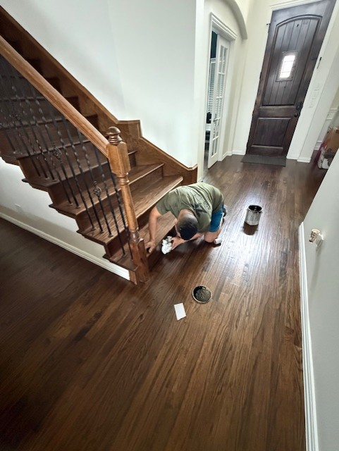 Craftsman installing hardwood floors in a Frisco home