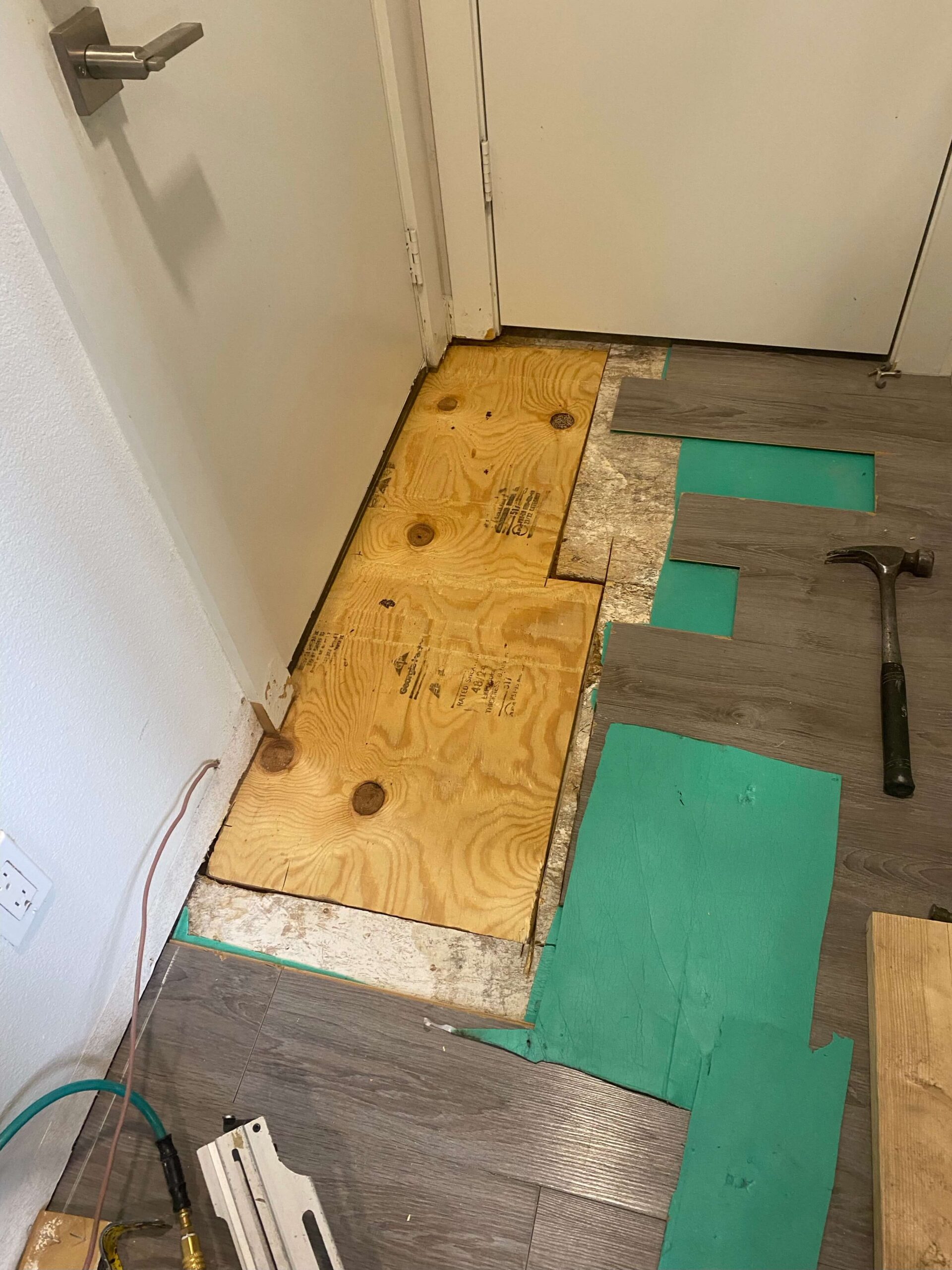 Hardwood floor removed to the plywood subfloor on a Dallas water damage job