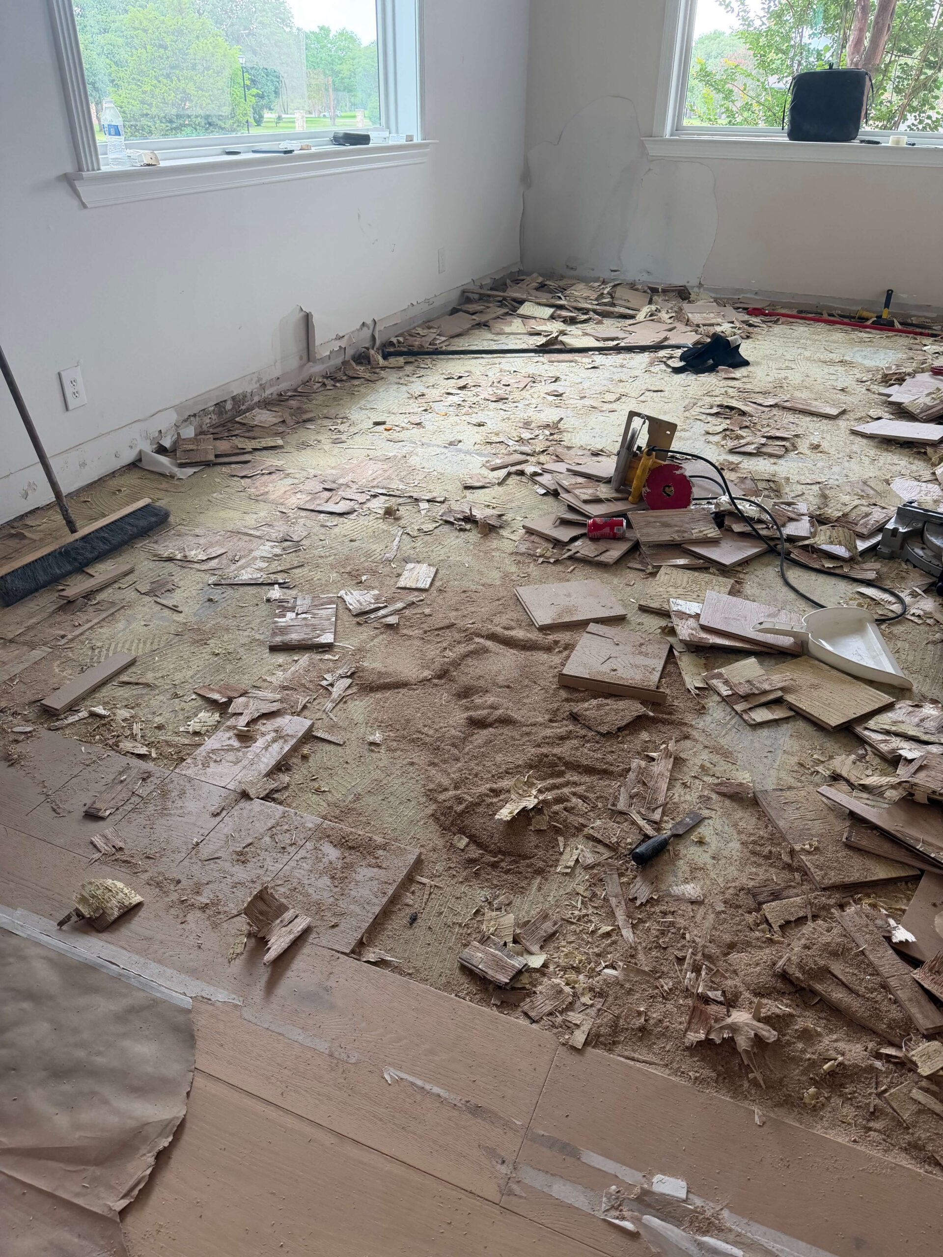 Wide plank engineered floor being removed after water damage